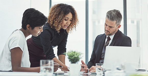 Colleagues consult with each other in a meeting