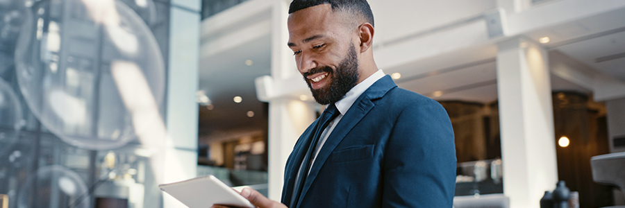 Businessman in an office looking at a tablet computer