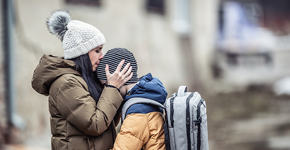 A women kissing her child on the forehead