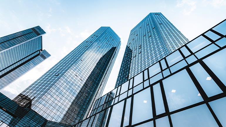 Looking upwards surrounded by tall office buildings.